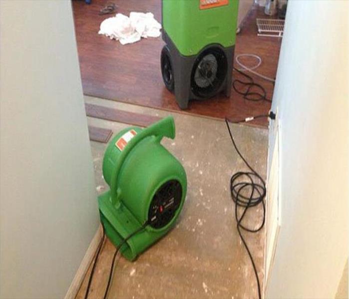 drying devices in hallway, floor boards removed