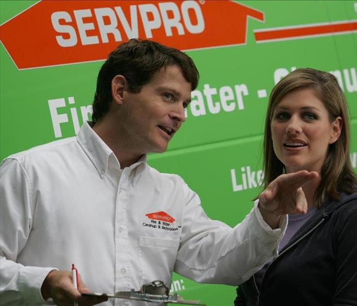 SERVPRO Employee talking with a client.